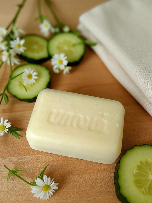 soap on a linen cloth with fresh sliced cucumbers and dainty white flowers