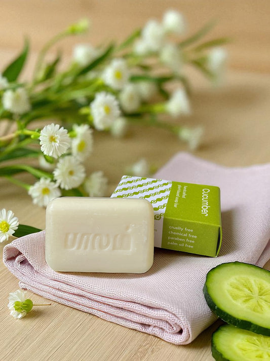soap on a linen cloth with fresh sliced cucumbers and dainty white flowers